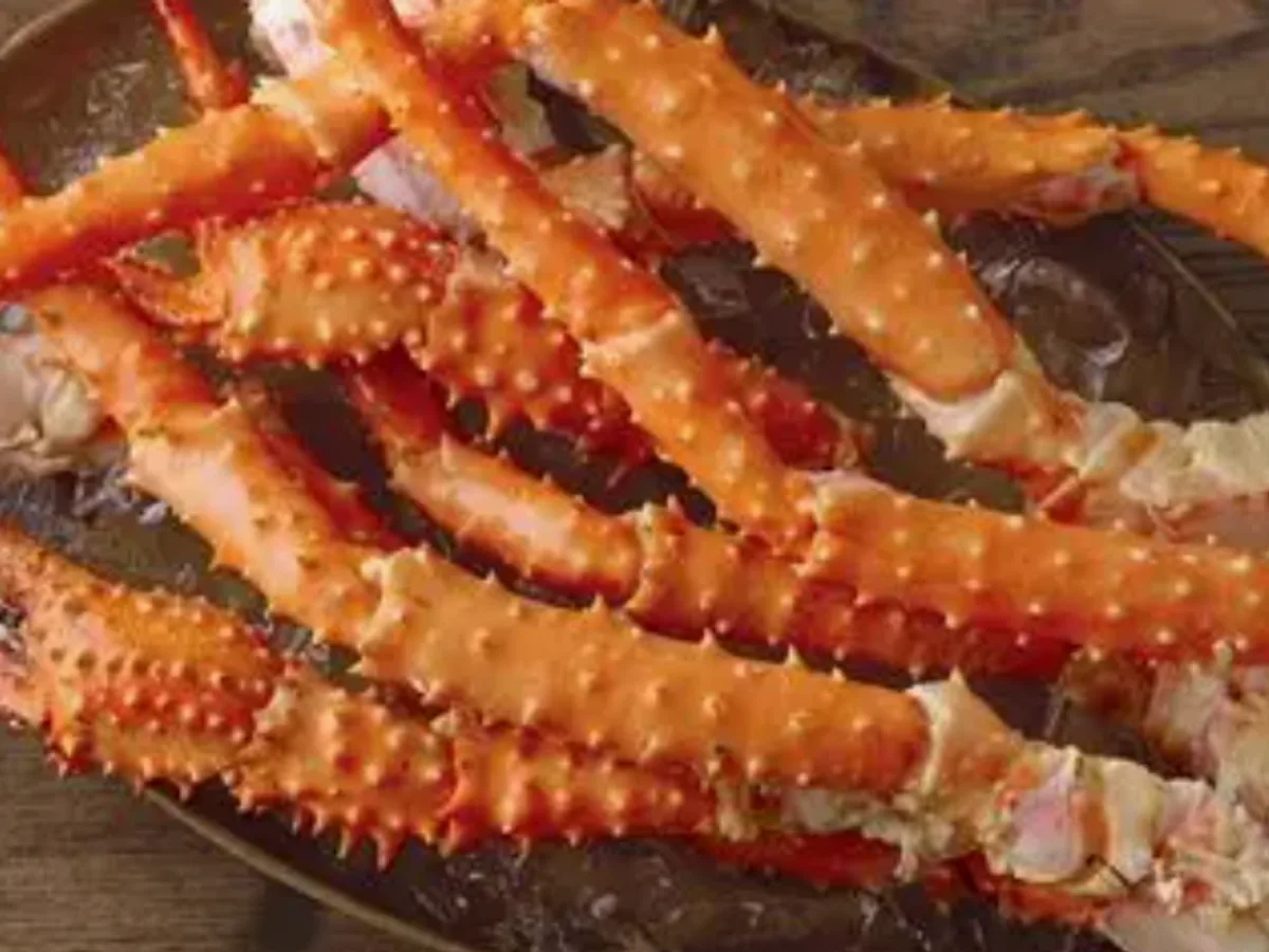 Cooked red king crab legs piled on a platter